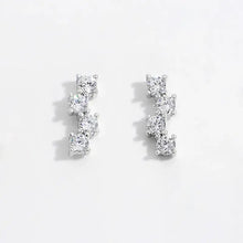 Pair of sterling silver stud earrings with four descending cubic zirconia stones