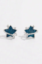 Pair of 925 sterling silver star earrings with teal textured zircon centers