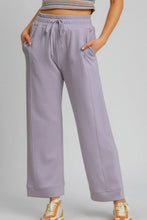 Lavender-colored umgee drawstring elastic waist wide leg pants with fits waist drawstring and side pockets