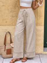 Beige linen casual drawstring wide leg pants with lace trim at the hem for comfortable stylish wear