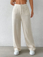 Beige linen wide leg pants with front pockets and button closure for a comfortable stylish look