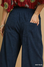 Navy blue umgee wide-leg corduroy pants with elastic waistband and two front pockets for comfortable style