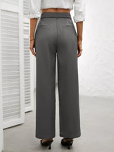 Gray high waist wide leg trousers with a sleek tailored fit and subtle front pockets for a polished look