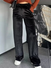 Black velvet wide leg pants with a drawstring waistband featuring velvet wide leg design for elegant comfort