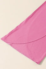 Soft pink knotted waist split leg relaxed pants made of smooth fabric with subtle sheen and neatly stitched hemline