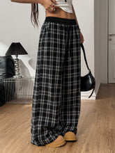 Black and white plaid wide-leg pants with elastic waistband featuring a comfortable fit and classic pattern