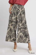 Black and cream wide leg culotte pants with bold palm leaf print featuring tropical leaf pattern by umgee