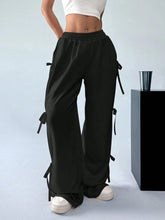 Black cargo wide leg pants with drawstring waist and side tie details in lightweight fabric for casual wear