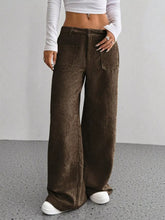 Brown corduroy wide leg pants with corduroy texture and two front pockets, perfect for pairing with ankle boots