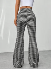 High waisted flare pants in black and white houndstooth pattern perfect for stylish casual or office wear