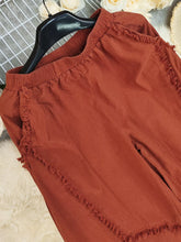 Rust-colored frayed edge harem pants made of cotton with an elastic waistband for comfortable wear