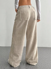 Beige corduroy wide leg pants with relaxed fit and back pockets showcasing corduroy texture for ankle boots styling