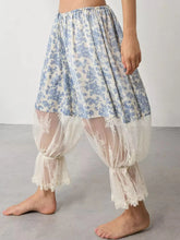 Blue and white floral lace patchwork pants with wide-leg design and sheer lace cuffs for elegant casual wear