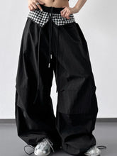 Wide leg pants in black with contrasting black and white checkered waistband and drawstring ties for casual wear