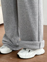 Gray heathered casual drawstring high waist sweatpants with rolled cuffs and a soft plush wide leg design