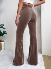 Brown corduroy high waist flare pants with vertical ribbed texture featuring a high waist design