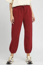 Umgee fleece jogger pants in crimped red cotton with a drawstring waist and elastic cuffs provide comfort and style