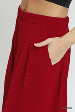 Crimson umgee elastic waist wide leg pants with textured fabric pleats and side pockets featuring an elastic waistband
