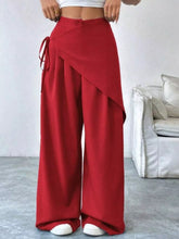 Red wrap-front wide-leg pants with a side tie in soft flowing fabric featuring a wide leg silhouette