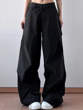 Black wide leg oversized pants with relaxed straight-cut silhouette and subtle pleats at the waistband care instructions included