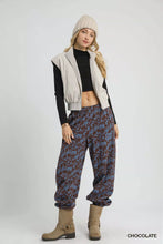 Beige knit beanie with ribbed texture and slouchy fit paired with umgee scenic print casual sweatpants