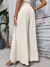 Cream-colored wide leg drawstring casual pants with elastic waistband and flowing relaxed fit for comfortable wear