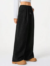 Black wide leg corduroy drawstring pants with elastic waistband for comfortable casual wear