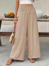 Beige wide leg trousers with smocked waist high rise and two front pockets in smocked waist wide style