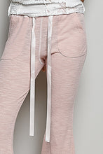 Pink textured ribbed knit pants with white drawstring and side pockets in ribbed knit fabric for casual wear