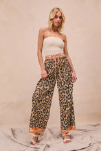 Bibi leopard print wide-leg trousers featuring orange trim and a drawstring waistband for stylish comfort
