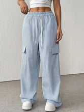 Light blue and white vertically striped wide leg cargo pants with elastic waistband and drawstring striped wide leg design