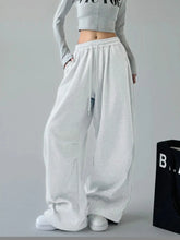 White oversized wide leg sweatpants with drawstring waistband and side pockets in loose-fitting soft fabric