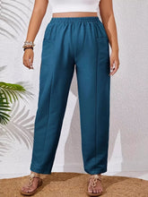 Plus size teal casual pants with relaxed fit, elastic waistband, fabric blend, and two front pockets for comfort
