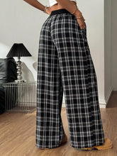 Black and white plaid wide-leg pants with elastic waistband designed for comfortable stylish wear