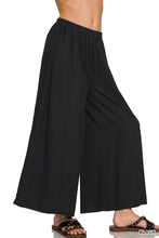 Black zenana woven pleated wide leg pants with elastic waistband and flowing woven pleated linen blend fabric