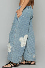 Light blue denim wide-leg pol floral patch pants with subtle white dots and distressed frayed crochet see thru patches