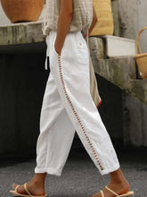 White linen hollow out trim cropped pants featuring decorative embroidered trim along the side seam