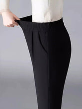 Black elastic waist loose fit trousers with sleek straight-leg cut and subtle front pleats for comfortable wear