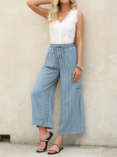 Contrast striped wide leg pants featuring blue and white vertically striped wide leg design with drawstring waistband
