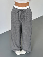Black and white striped wide leg drawstring pants with a comfortable waistband for casual and stylish wear