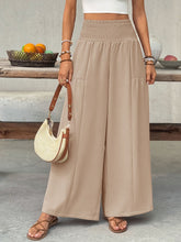 Beige smocked waist wide leg pants with a high smocked waist and two front pockets for a comfortable fit