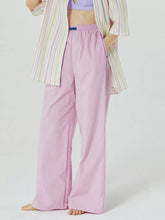 Pastel pink wide leg trousers with an elastic waist and subtle side seam detail in elastic waist wide style