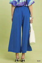 Vibrant royal blue umgee linen elastic waist wide leg pants with tailored fit and subtle pleats at the waistband
