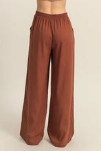 Brown hyfve wide-leg pants with elastic waistband designed for comfort and easy care instructions