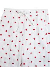 White pleated shorts with red heart print and matching heart print drawstring waistband for casual wear