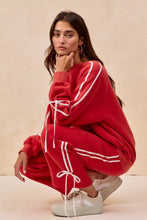 Red oversized sweatshirt with white striped side panels and bow details fleece drawstring ties for casual wear