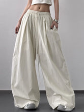 Cream-colored striped wide leg drawstring pants with subtle vertical stripes and elastic waistband for comfort