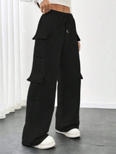 Black wide-leg cargo pants with multiple flap pockets and a casual drawstring loose fit waist for everyday wear