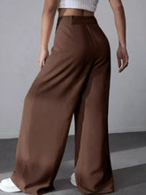 Brown high-waisted wide leg pleated pants made of smooth flowing fabric offering elegant leg pleated pants style