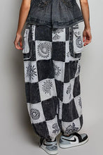 Black and white patchwork jogger pants in soft cotton fabric with embroidered floral and geometric patterns
